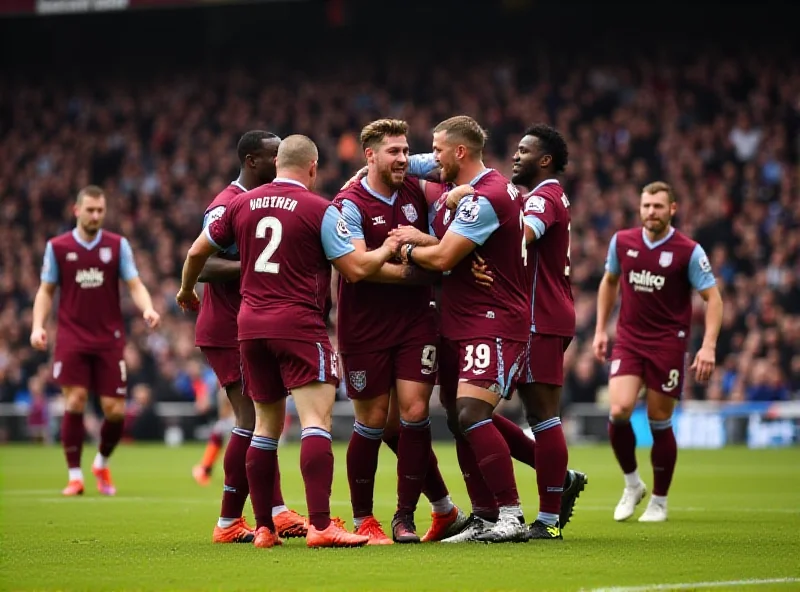 Aston Villa team celebrating a goal, high-fiving and smiling.