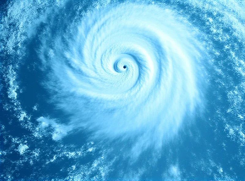 Satellite image of a large tropical cyclone approaching the coast of Queensland, Australia. The coastline is visible in the background.