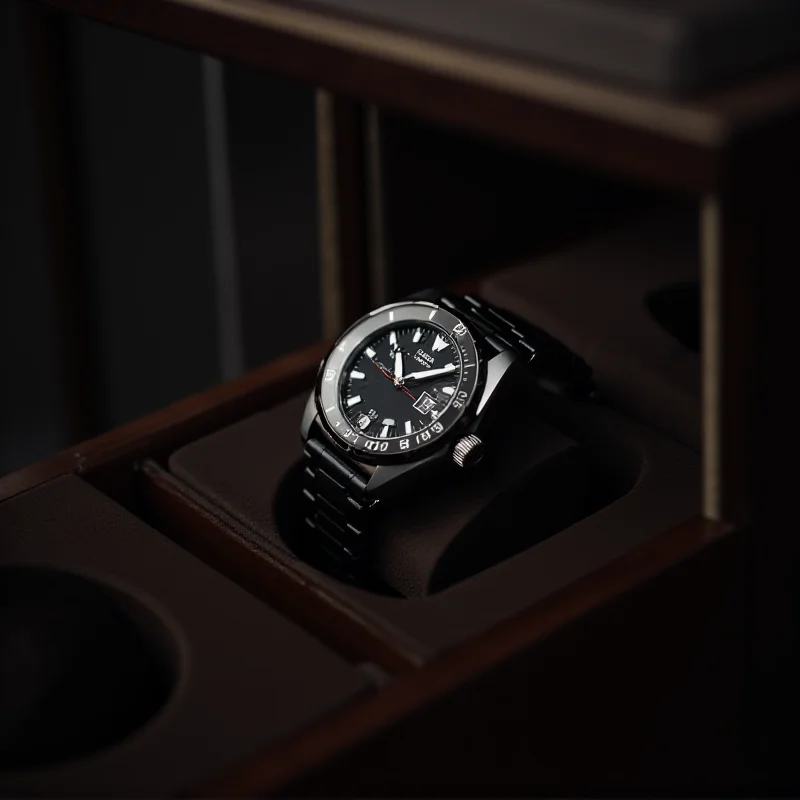 A close-up of a TAG Heuer watch being carefully placed in a high-quality watch winder.