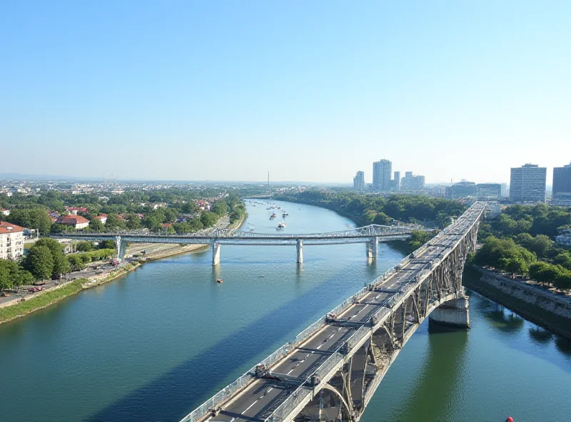 Wide shot of the SNP Bridge in Bratislava, showing the UFO observation deck and the riverside promenade, with construction work visible in the background.