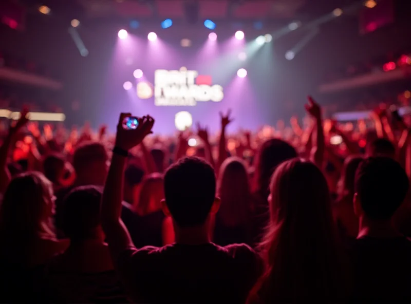 Crowd at the Brit Awards, cheering and holding up their phones