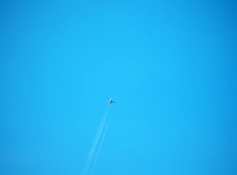 An airplane flying through a cloudy sky. 