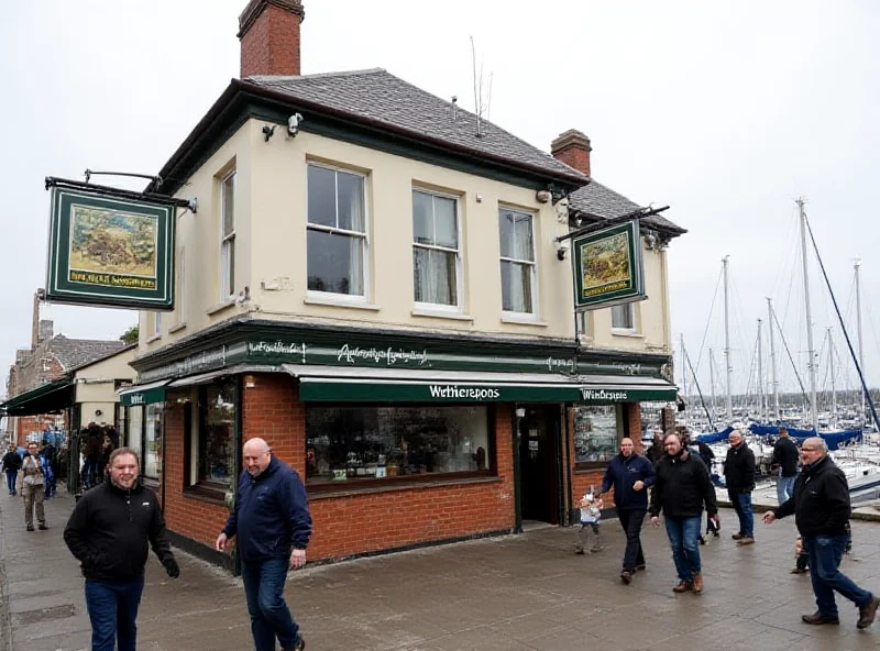 Exterior of a Wetherspoons pub with a sign. The pub is located near a marina.