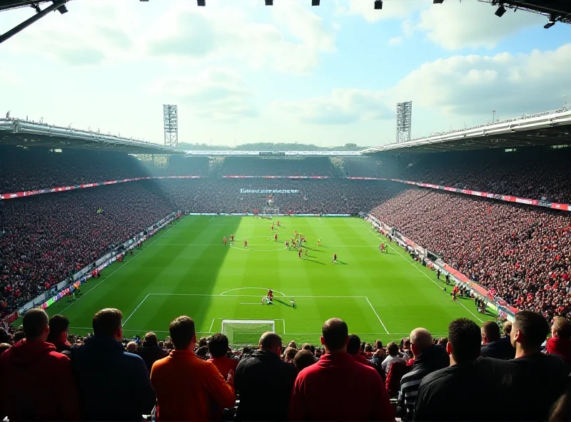 A packed football stadium with green field and players in the distance.