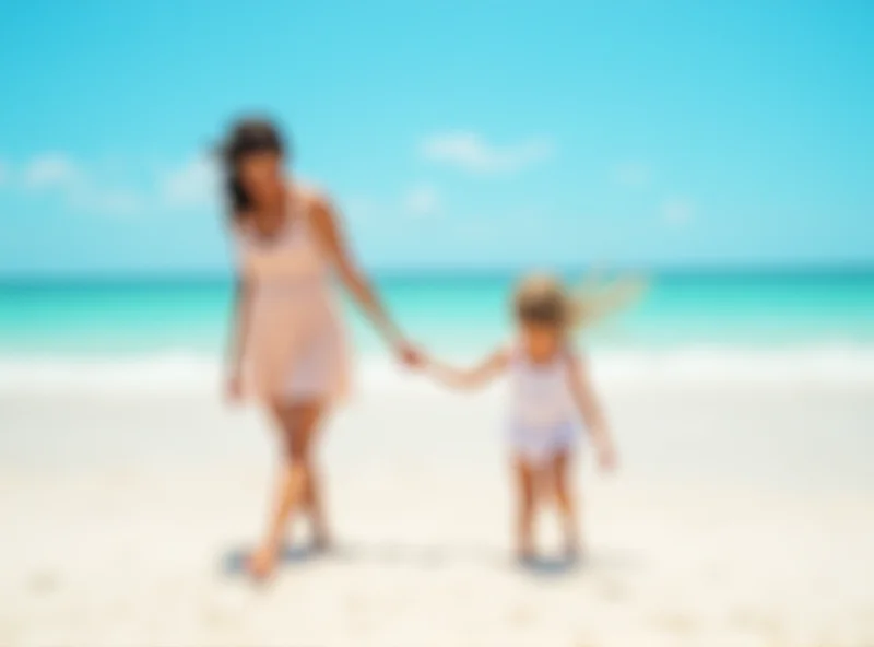 A mother and child walking on a sunny beach near the ocean.