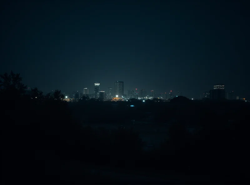 A darkened Chilean city at night, lit only by vehicle headlights.