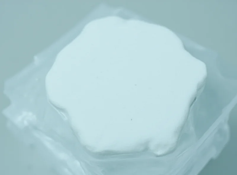 A close-up of laundry detergent sheets in a clear plastic container, with a fresh scent label visible.