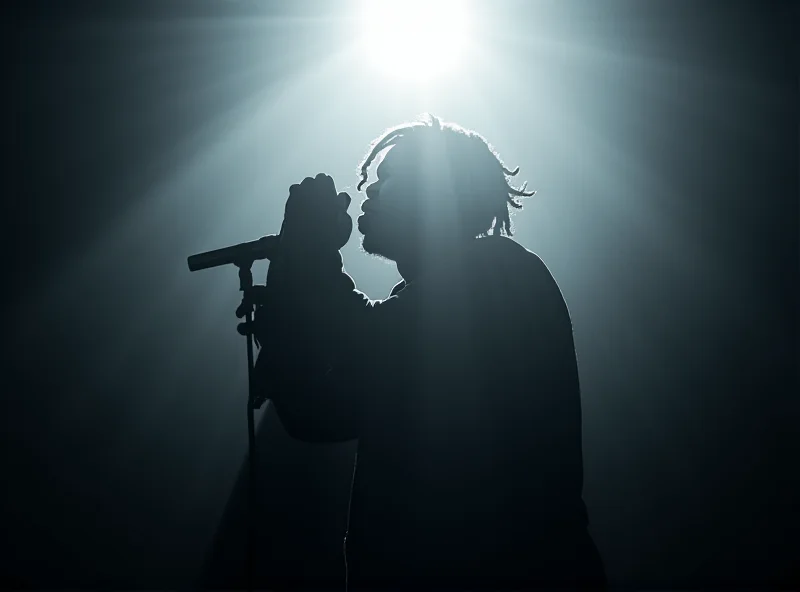 Kendrick Lamar performing on stage, silhouetted against a bright spotlight.