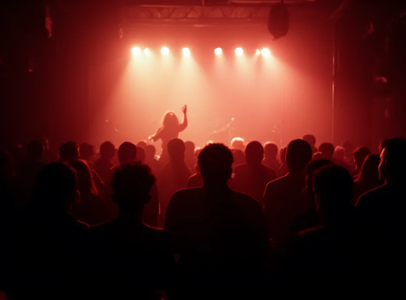 A packed concert crowd silhouetted against a brightly lit stage at Cafe Oto in Dalston, London.