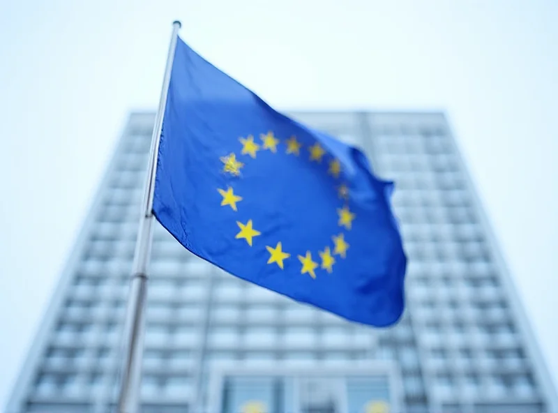 European Union flag waving in front of the European Commission building in Brussels