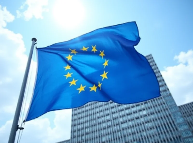 European Union flag waving in front of the European Parliament building in Brussels.