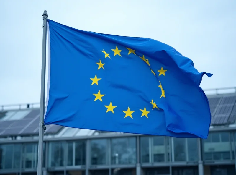 European Union flag waving in front of a modern factory.