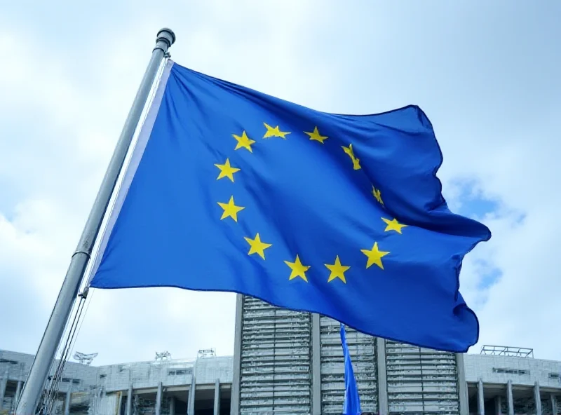 European Union flag waving in front of the European Parliament building in Brussels.