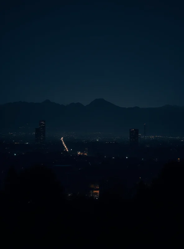 A darkened cityscape in Chile during the blackout, with only a few lights visible.