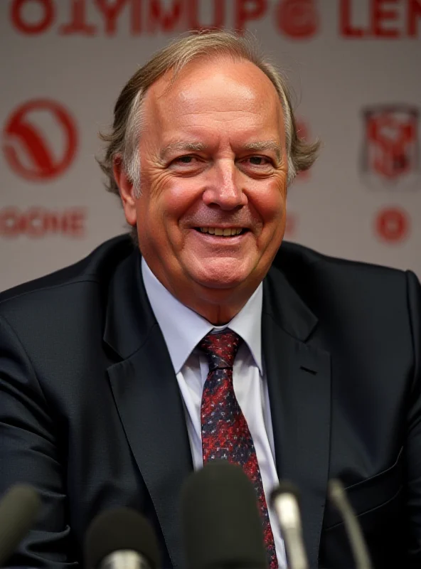 A photo of John Textor, owner of Olympique Lyon, smiling confidently.