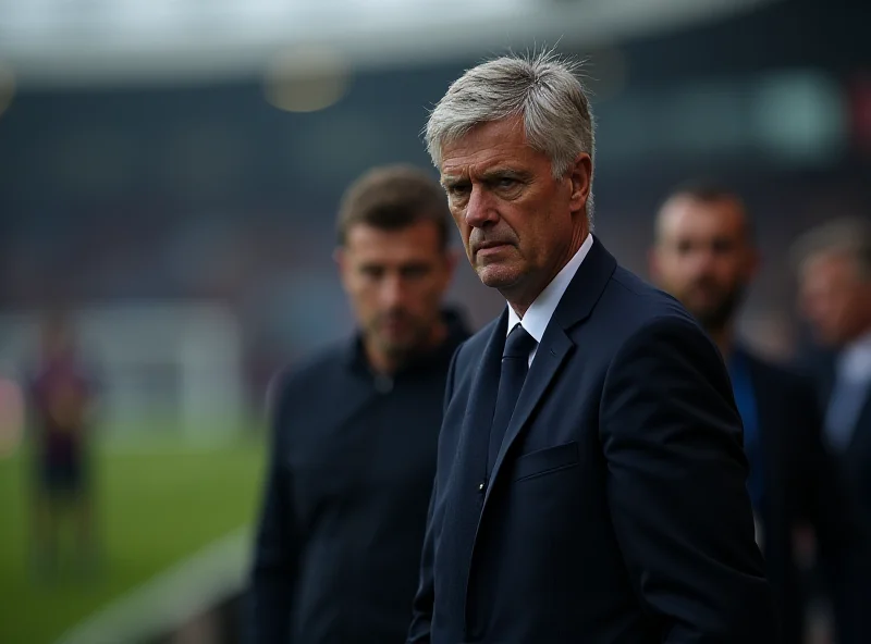 Jose Mourinho standing on the sidelines during a game, looking pensive.