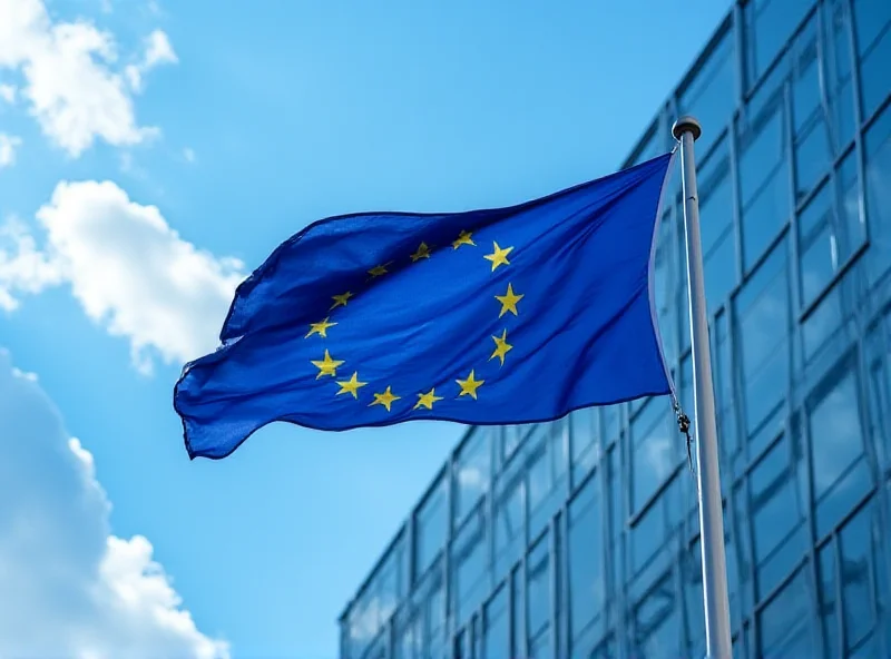 European Union flag waving in front of a modern government building.