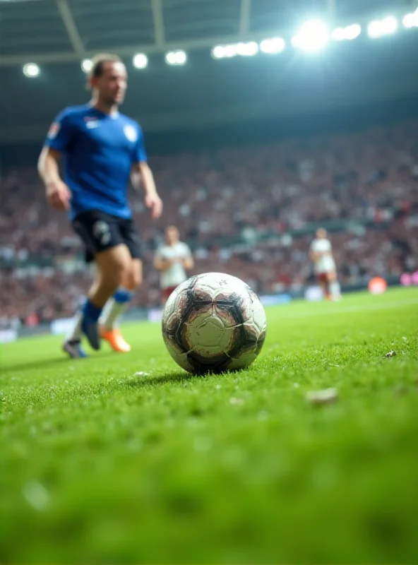 Close-up of a soccer ball being kicked during a match. The background is blurred, showing the players and the stadium.