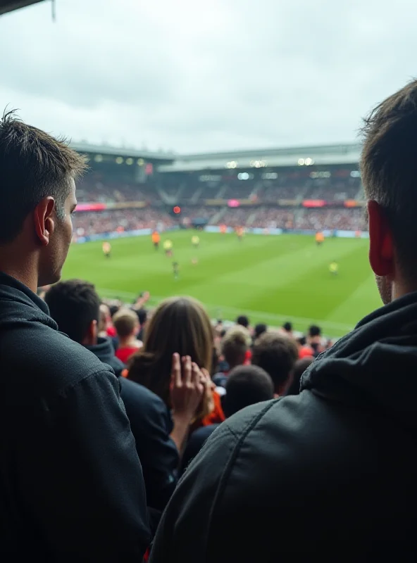 A concerned crowd watches a football match in progress.