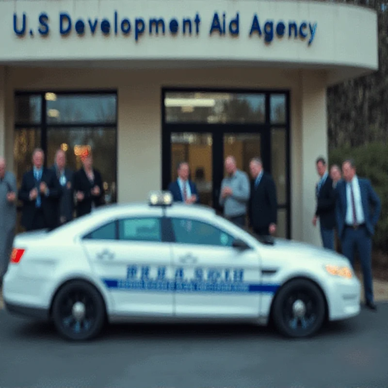 Police car parked outside a US development aid agency building.