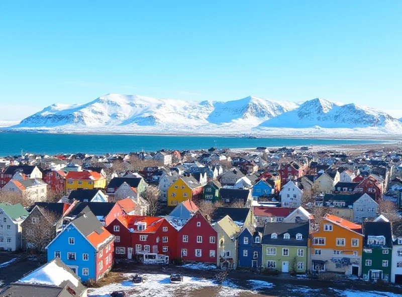 A scenic view of Reykjavik, the capital of Iceland, with colorful buildings and snow-capped mountains in the background, under a clear blue sky.