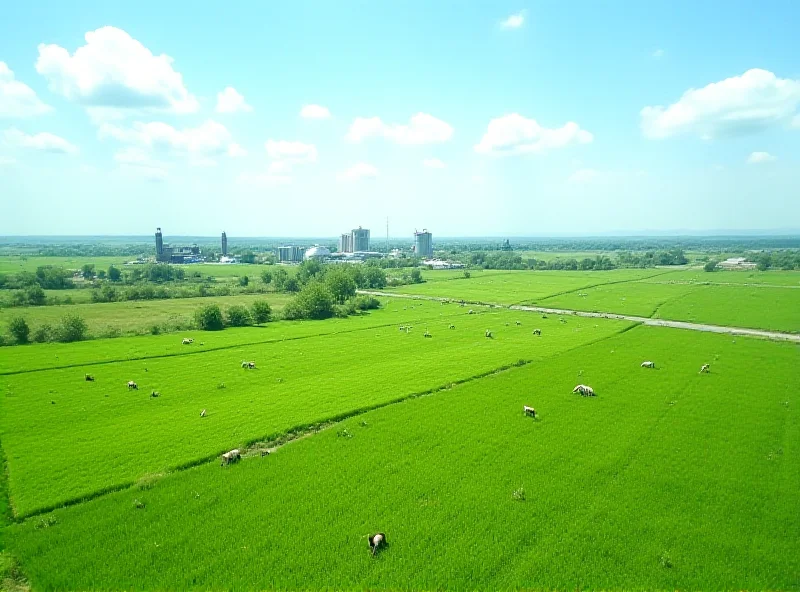 Aerial view of lush green agricultural fields in Kyrgyzstan, with modern processing facilities in the background