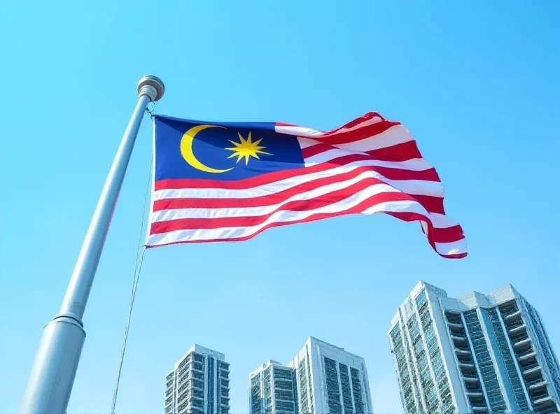 Image of the Malaysian flag waving in front of government buildings in Kuala Lumpur.