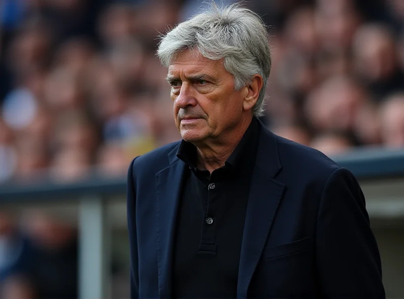 José Mourinho stands on the sidelines during a football match, looking intense.