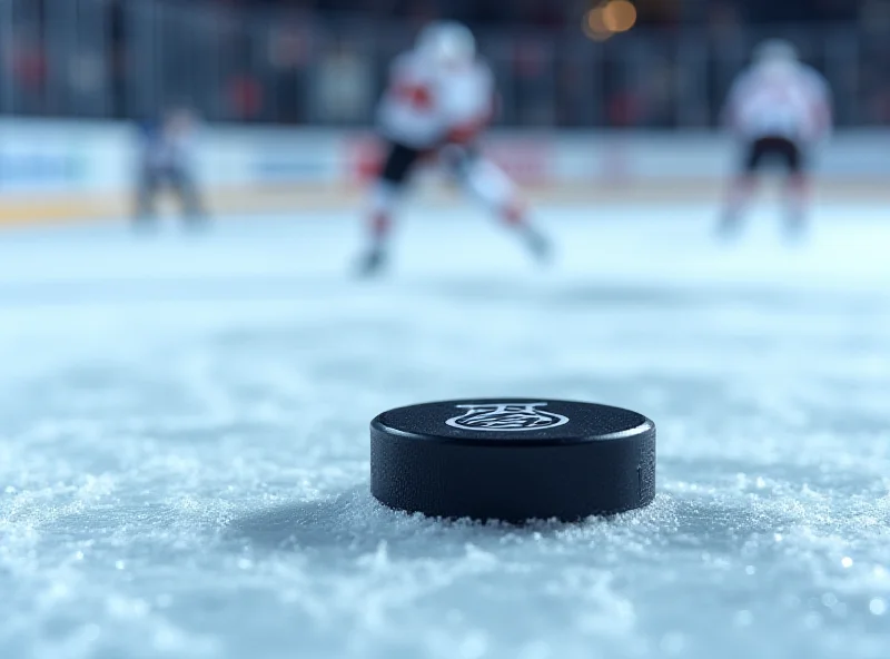 A hockey puck on the ice with a blurred background of players.