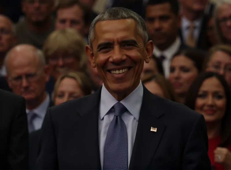 Barack Obama smiling warmly at a crowd, wearing a suit and tie.