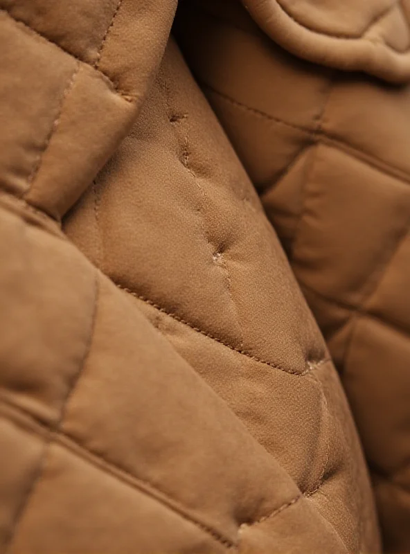 Close-up shot of a quilted coat from Chloé's Fall-Winter collection, showcasing texture and detail.