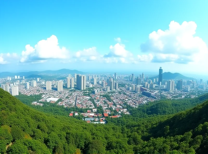 A panoramic view of Ipoh, Malaysia, showing the city skyline with a mix of modern and traditional buildings under a bright blue sky.