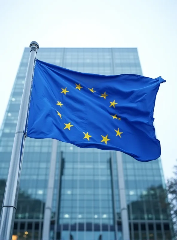 European Union flag waving in front of the Berlaymont building in Brussels, Belgium.