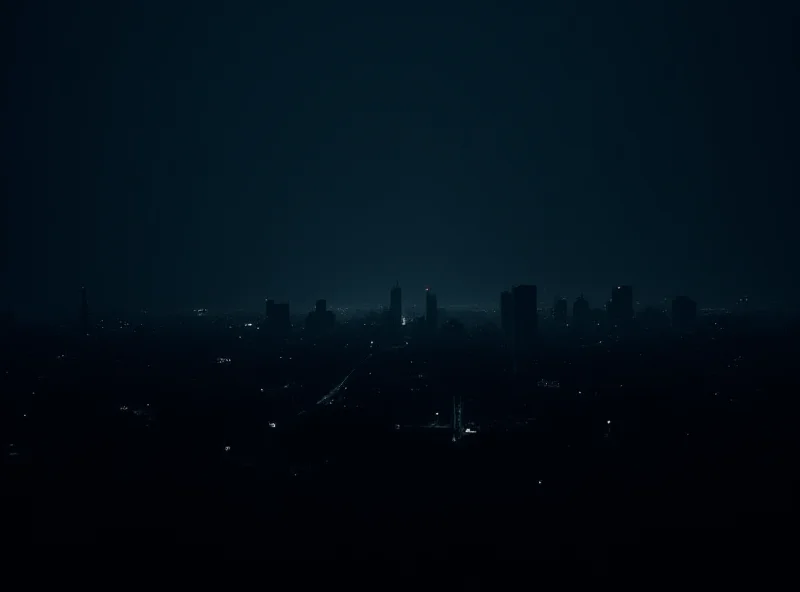 A darkened city skyline with faint lights in the distance, symbolizing a widespread blackout