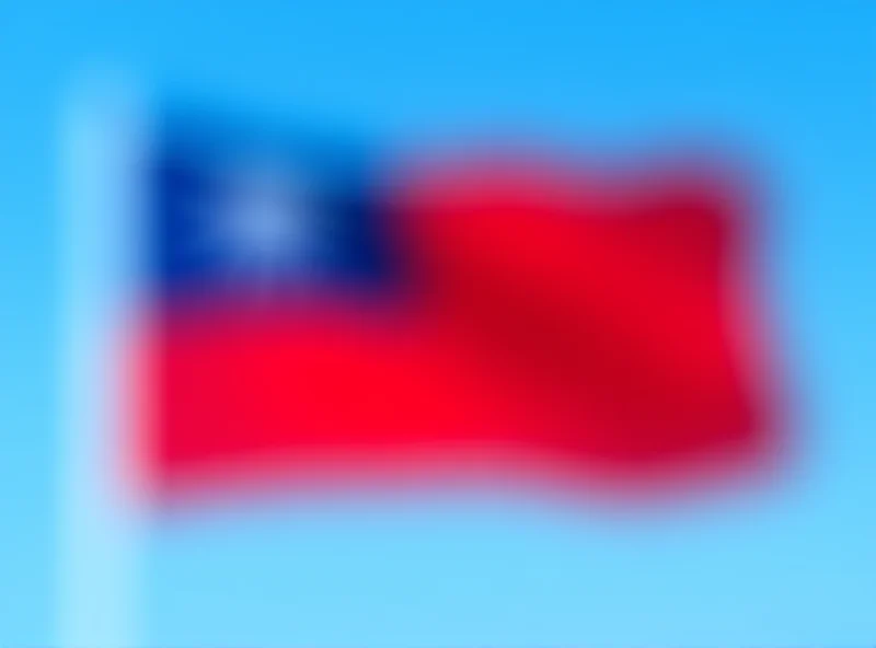 Image of the Taiwanese flag waving in the wind against a clear blue sky.