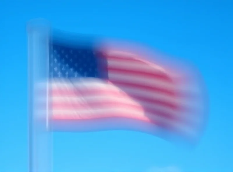 Image of the American flag waving in the wind against a clear blue sky.