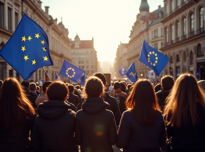 A large crowd of people holding European Union flags and banners in a city square.