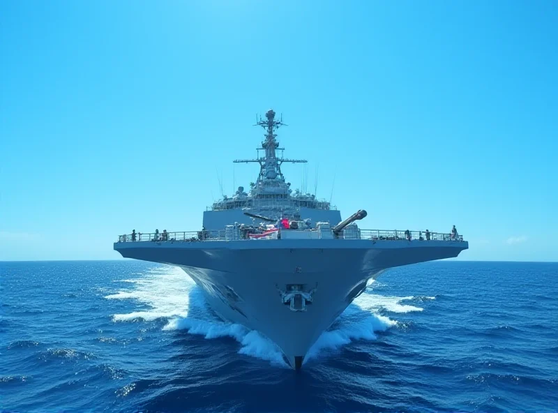 A modern warship sailing on the open ocean.