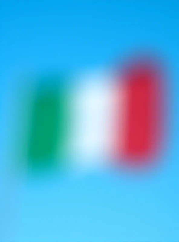 The Italian flag waving in the wind against a bright blue sky. The flag is crisp and clear, and the sky is cloudless.