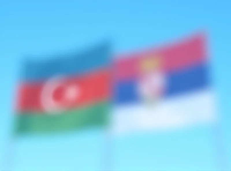 Image depicting the flags of Azerbaijan and Serbia flying side-by-side, symbolizing bilateral relations.