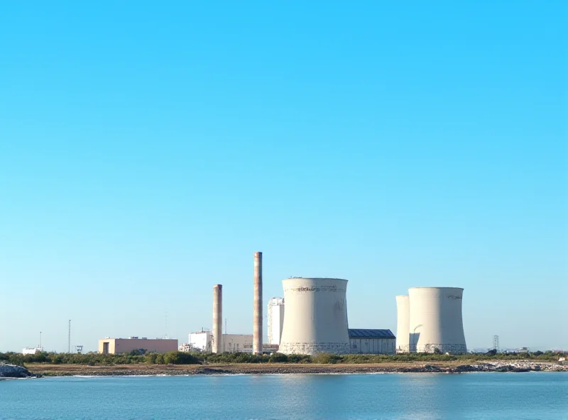 A nuclear power plant in Spain, with cooling towers and industrial buildings, set against a clear blue sky, symbolizing the debate over energy policy.