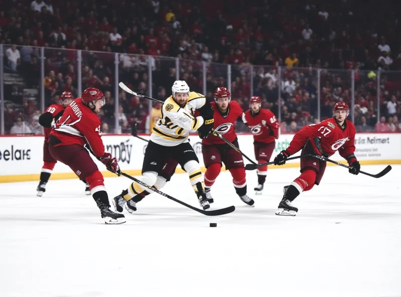 A tense moment during the Bruins game against the Hurricanes, players battling for the puck.