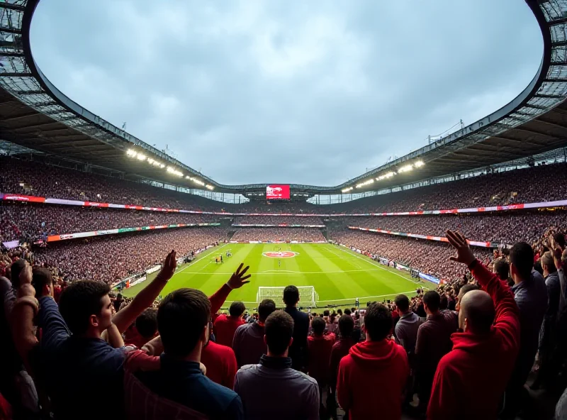 A modern stadium packed with cheering fans during a Premier League game.