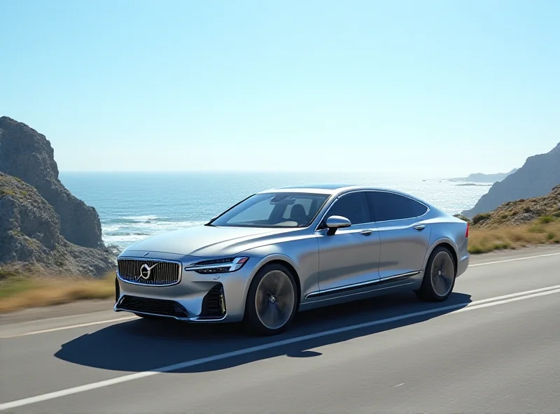 Sleek silver Volvo ES90 electric sedan driving on a coastal road with the ocean in the background.