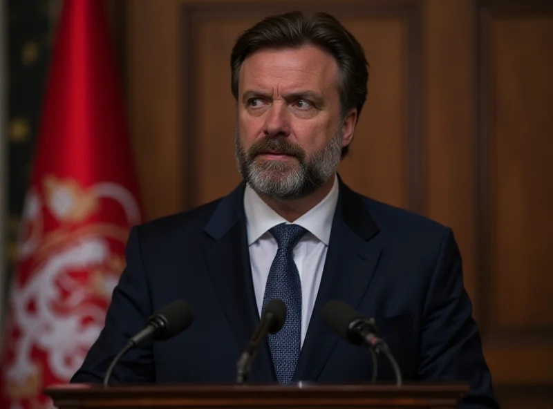 Aleksandar Vulin speaking at a press conference, serious expression, Serbian flag in background