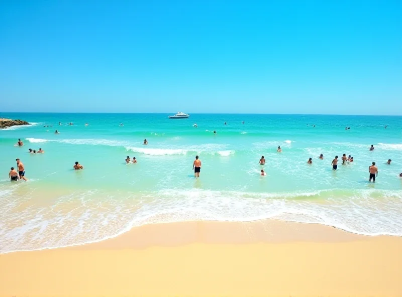 Surfers catching waves in Praia da Luz, Algarve, Portugal.