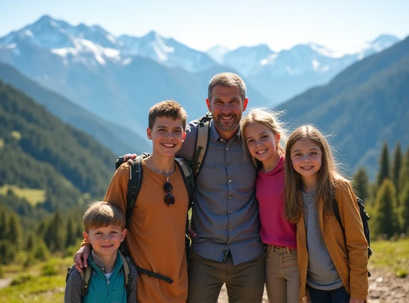 A family of four stands in front of a scenic mountain view, smiling at the camera. The children are young, around 4 and 6 years old.