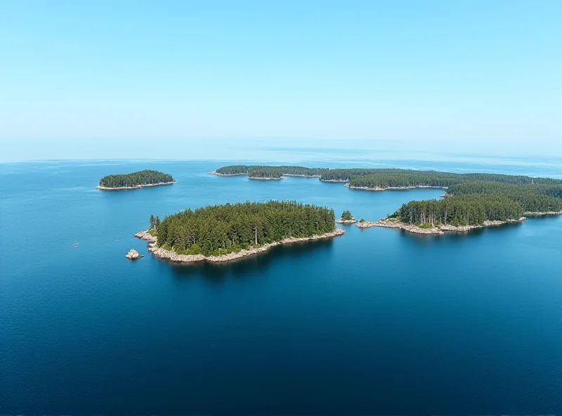 A panoramic view of the Västervik archipelago in Sweden, showing numerous small islands covered in trees and surrounded by calm, blue water. The sky is clear and sunny.