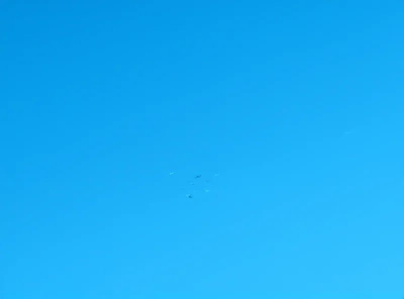 Image of fighter jets flying in formation, leaving contrails in the sky.