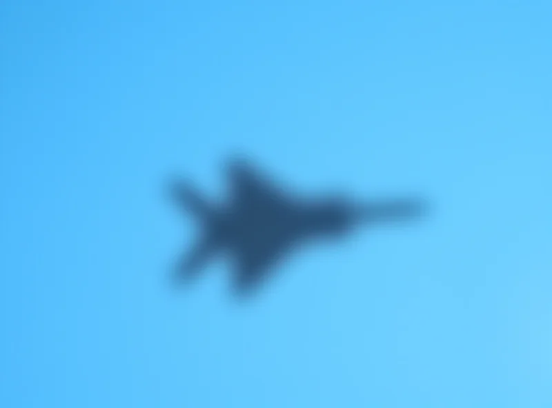 RAF Typhoon fighter jet flying in a blue sky.